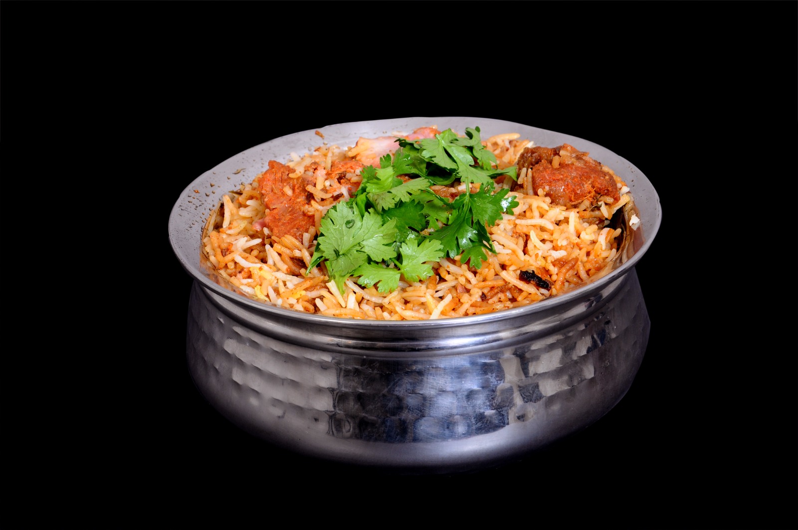 Close-up of Hyderabadi Dum Biryani in a hammered steel handi