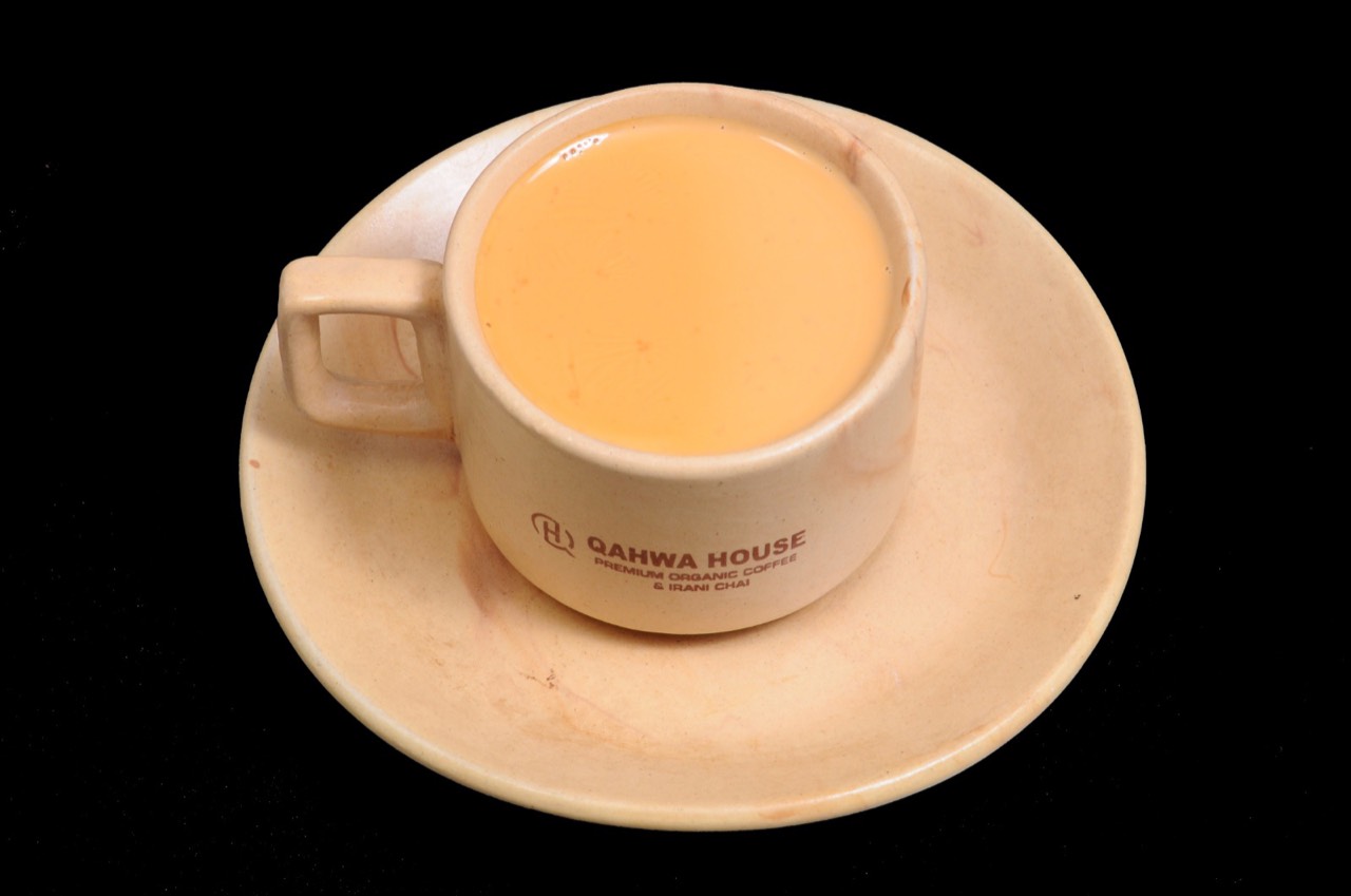 Top-down view of Irani chai in a Qahwa House cup